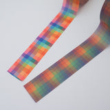 Two rolls of washi tape with a checked pattern. One is brightly coloured and the other is in dusky rainbow hues.