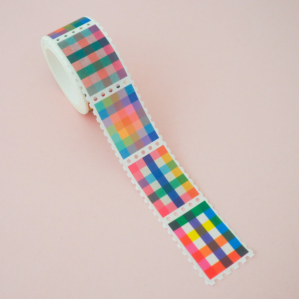 Roll of washi tape in a stamp style with perforated edges. Each stamp has a different, colourful gingham-patterned design.