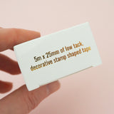 The bottom of a gold-foil printed box for washi tape.