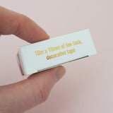 The bottom of a gold-foil printed box for washi tape.