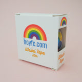 A colourful roll of washi tape in a gold foil-printed, windowed box.
