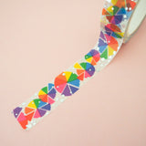 Roll of white washi tape with rainbow colour wheels in segments which change colour where they overlap. Accented with silver foil.