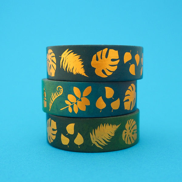 Stack of green gradient washi with a variety of gold-foil plants and leaves.