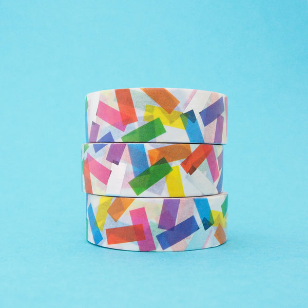 Stack of white washi tape with a scattered design of colourful rectangles. The colours change where the rectangles overlap. Accented with silver foil rectangles.