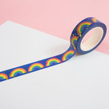 Roll of deep blue washi tape featuring rainbows and colourful foil accents.