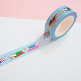 Light blue washi tape printed with small stacks of colourful books and gold-foil sparkles.