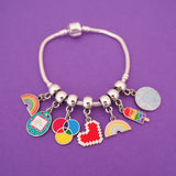Silver bracelet threaded with multiple enamel charms on smooth cup bail beads. Charms are of various colourful designs.