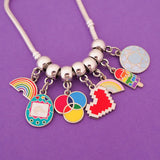 Silver bracelet threaded with multiple enamel charms on smooth cup bail beads. Charms are of various colourful designs.