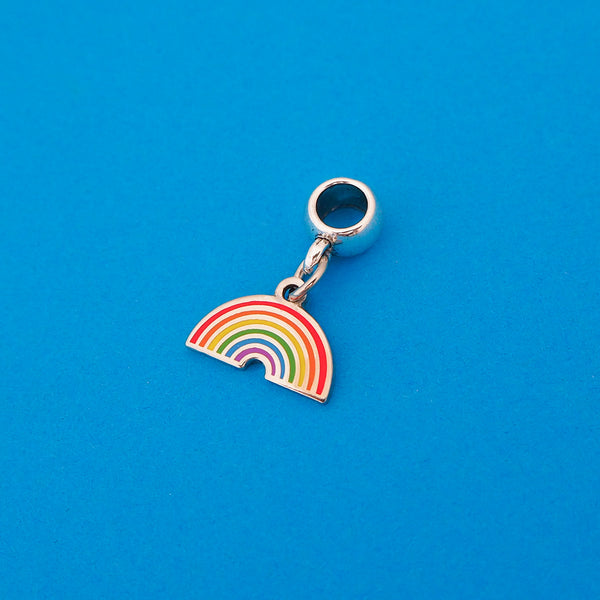Enamel charm on a smooth cup bail bead. Charm depicts a brightly coloured rainbow.