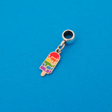Enamel charm on a smooth cup bail bead. Charm is in the shape of an ice lolly and has horizontal rainbow stripes with the bright colours dripping into neighbouring sections like it is melting.
