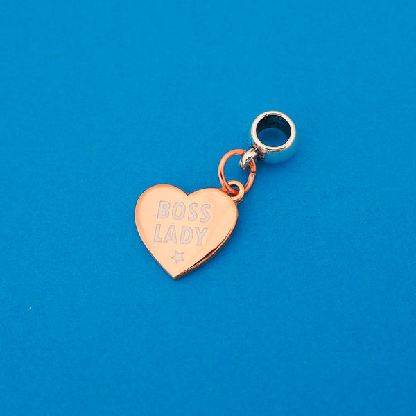 Rose-gold plated charm on a smooth cup bail bead. Charm is heart-shaped and Boss Lady in white capitals with a little white star beneath.