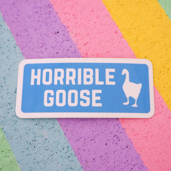 Rectangular, blue vinyl sticker with a white border and rounded corners. It reads Horrible Goose in white capitals with a goose silhouette in white on the right.