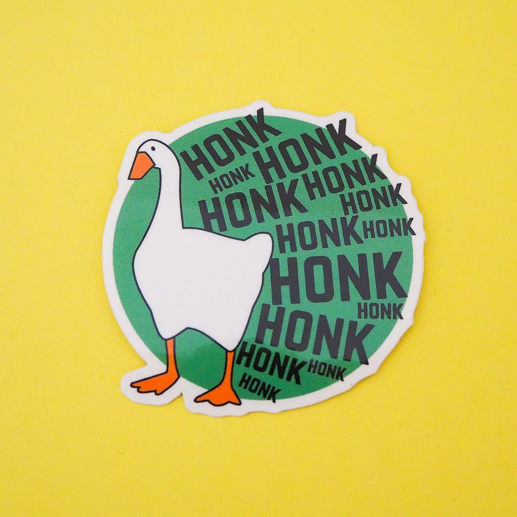 Green, circular vinyl sticker. On the left is a goose and the rest of the sticker is filled with the word Honk repeated in different sizes in black capitals. The goose and letters protrude over the edge of the circle. The sticker has a white border.