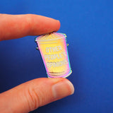 Rainbow-plated metal pin in the shape of a rubbish bin which reads Other People's Opinions in white capitals. Pin is held betwwen finger and thumb.