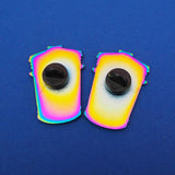 The back of two rainbow-plated metal pins, each having a black rubber backing.