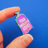 Rainbow-plated metal pin shaped to look like a bin bag. In the centre of the bag it reads Your Unsolicited Advice in white capitals. The pin is held between a finger and thumb.