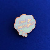 Enamel pin depicting a glittery, cloud-shaped thought bubble. Inside the bubble is the question Can I Go Home Yet? The metal has a rose gold finish.  The pin is shown on a dark blue background.