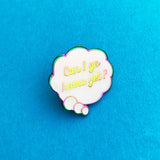Enamel pin depicting a white, cloud-shaped thought bubble. Inside the bubble is the question Can I Go Home Yet? The metal has a rainbow finish.  Pin is shown on a blue background.