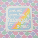 Square vinyl sticker with rounded corners that reads not all men but always a man in white script with decorative white sparkles. The background of the sticker is pale blue with pastel rainbow stripes running diagonally from top-right to bottom-left. The sticker has a white border.