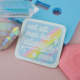 Square vinyl sticker with rounded corners that reads not all men but always a man in white script with decorative white sparkles. The background of the sticker is pale blue with pastel rainbow stripes running diagonally from top-right to bottom-left. The sticker has a white border.